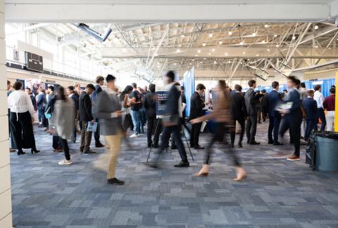 people walking around at an expo
